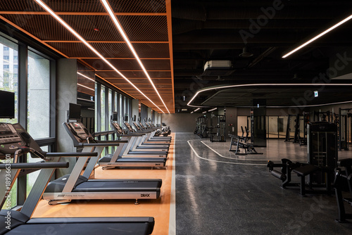 Rows of treadmills in a luxury high-tech fitness center gym