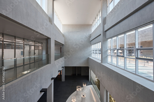 Photos High-ceiling atrium in modern office building with glass railings