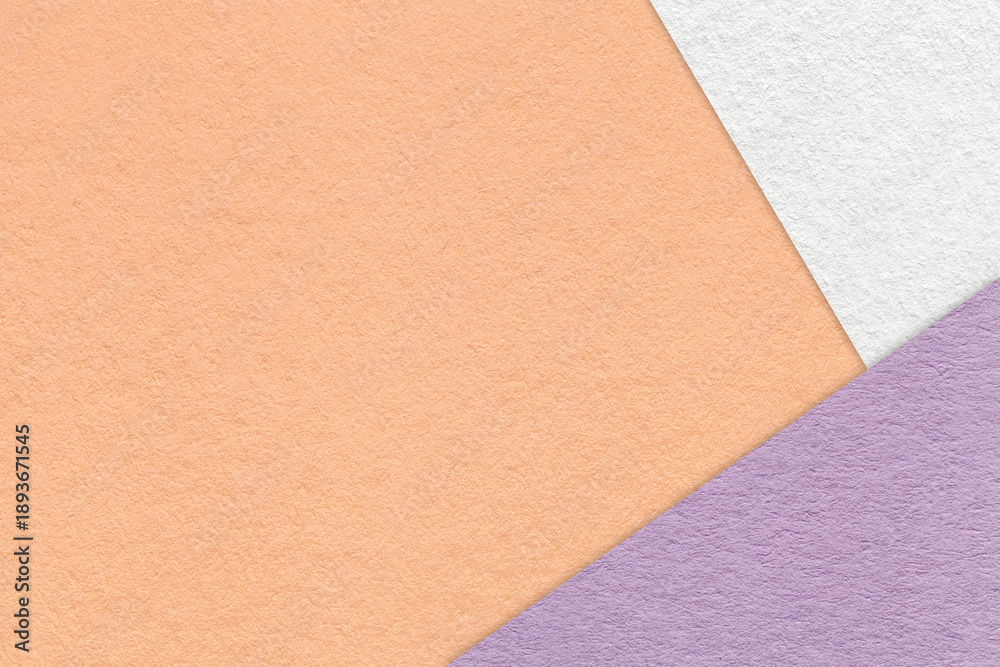 Fototapeta premium Peach textured paper background with white lilac triangular corners and copy space. Template for presentation, banner