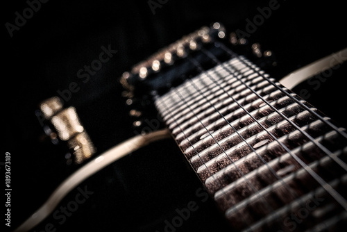 Photography Artistic macro close up of electric guitar fretboard with strings and frets show