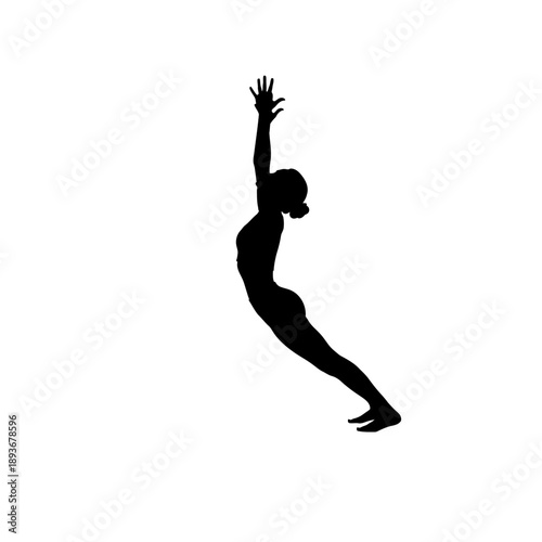 Silhouette of a woman practicing upward salute yoga pose.