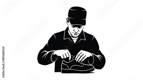 A man working with shoes rendered in a striking black and white silhouette