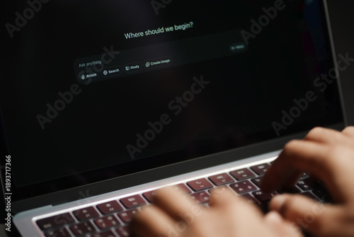 Fotografie The hands of a man using a laptop or smartphone to operate artificial intelligence (AI), inputting commands and interacting with AI, AI assistants, chatbots, chat GPT