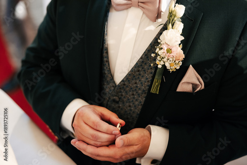 Bild auf Leinwand A bride and groom gently hold their wedding rings in their hands, symbolizing love and commitment