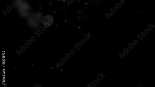 Tiny white air particles and micro-dust floating in a light beam.