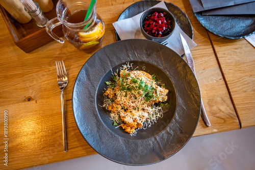 Wallpaper Mural Serbian risotto with grated cheese and parsley leaf on black plate on table. Drink, beetroot salad,napkin and second plate. Torontodigital.ca