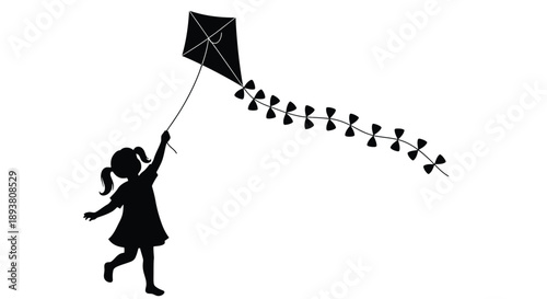 Silhouette of a girl flying a diamond shaped kite with a long tail