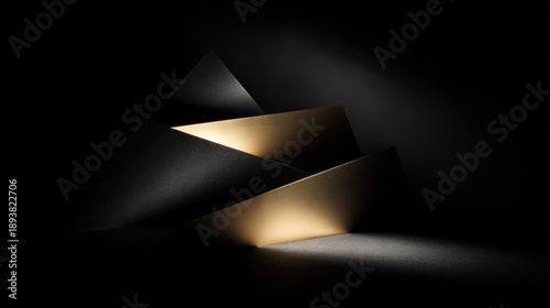 Black and gold abstract sculpture in the dark. the sculpture is made up of three triangular shapes, with the topmost triangle being the largest and the bottom two being the smallest.