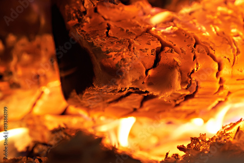 Homemade warm orange campfire with pieces of firewood. Burning firewood in the stove, coal, hot coals,
