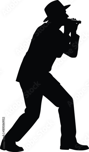 Silhouette of a man in a hat playing a harmonica or mouth organ musician
