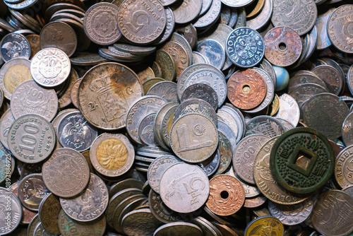 Pile of old Indonesian rupiah and vintage world coin collection for numismatic hobby or finance background with antique metal currency in scattered heap top view