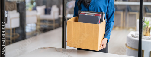 Valokuva Quit Job asian business woman sending resignation letter and packing Stuff Resign Depress or carrying business cardboard box in office