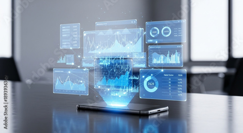 A futuristic smartphone on a sleek desk displays various floating blue graphs and charts in an office setting with blurred windows