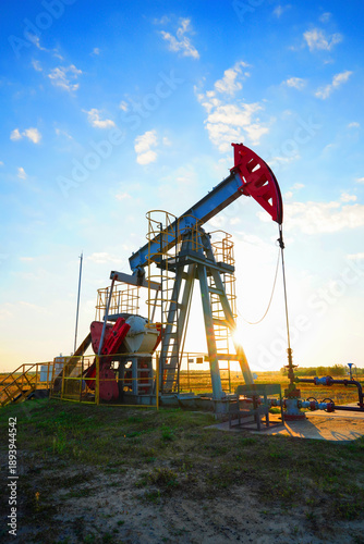 Fotografija Pumpjack in oil well of oil field on sunrise in Industrial crude area