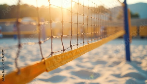 A close-up shot of a volleyball net, taut and ready for a game, with sunlight illuminating the strings  The sand is visible below, suggesting a beach volleyball court ,  concentration,  sport