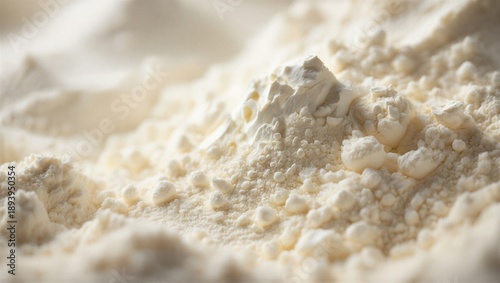 Fine white flour is piled up, showcasing its soft texture and fine grains. Baking and cooking ingredient.