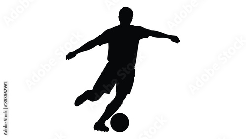 Silhouette of a soccer player in motion kicking a ball dynamically