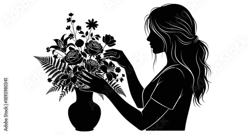 Woman arranges S flowers in vase on table indoors with care and attention to detail.