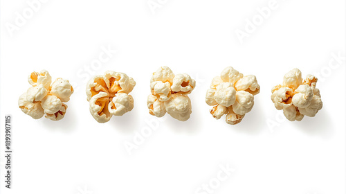 A digital photograph features five popped popcorn kernels on a white background, each with unique shapes and fluffy textures, showcasing yellow-orange centers.