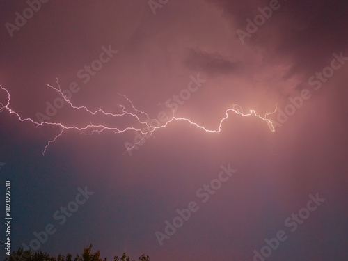 Canvastavla Bright flashes of lightning light up the dark sky as storm, signaling an impending downpour
