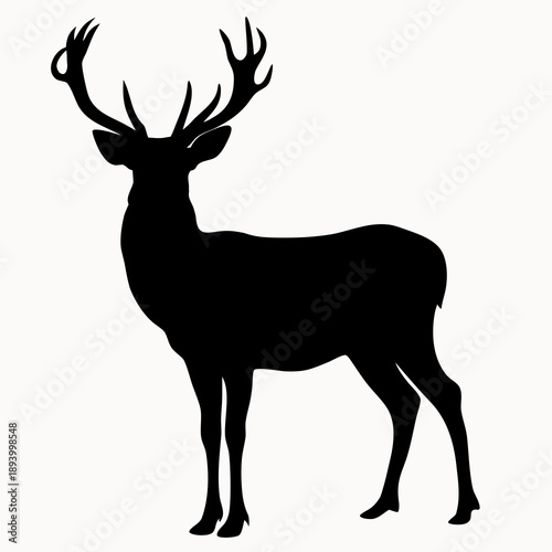 A black silhouette of a deer with large antlers standing proudly in a simple yet striking pose