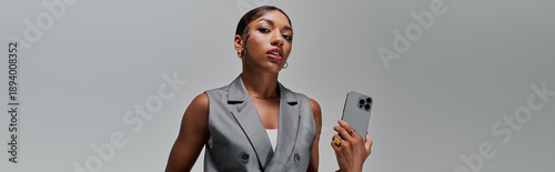 Stunning young woman exudes confidence in stylish smart casual attire in modern studio