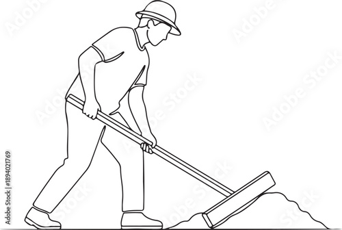 Man in hard hat working with a tool to level a pile of material on the ground