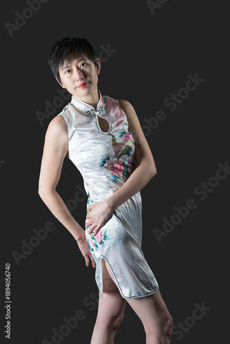 Chinese woman in white traditional dress leans backwards