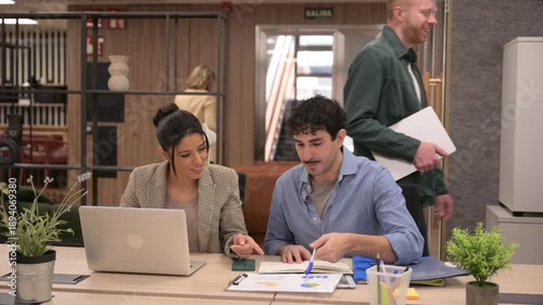 Senior female manager supervising colleagues working in modern office