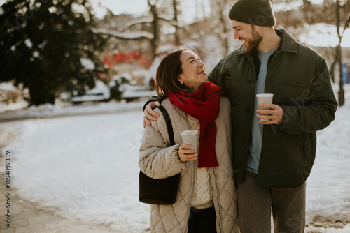 Couple walks in winter park...