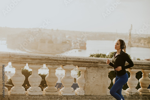 Woman runs by the waterfron...