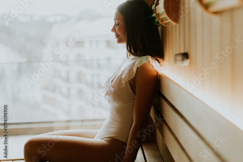 Woman sitting in a sauna we...