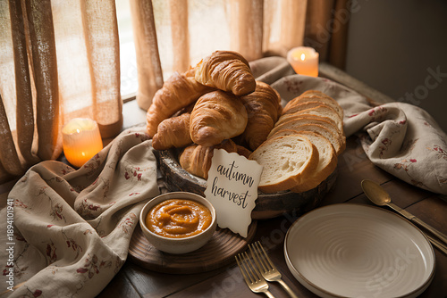 Cozy autumn harvest table setting with croissants and bread
