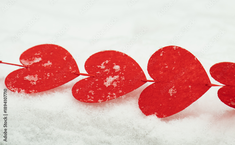 Fototapeta premium red hearts on the snow=