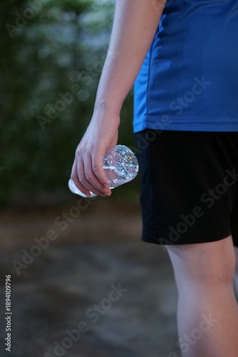 Woman Drinking Water After Outdoor Exercise