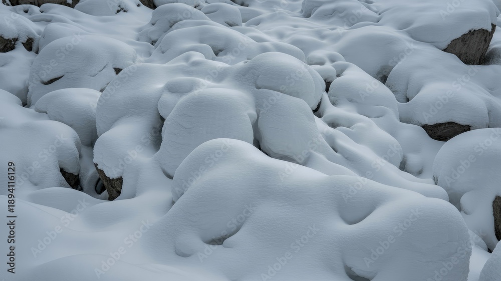 Obraz premium Snow covered rocks in serene winter landscape