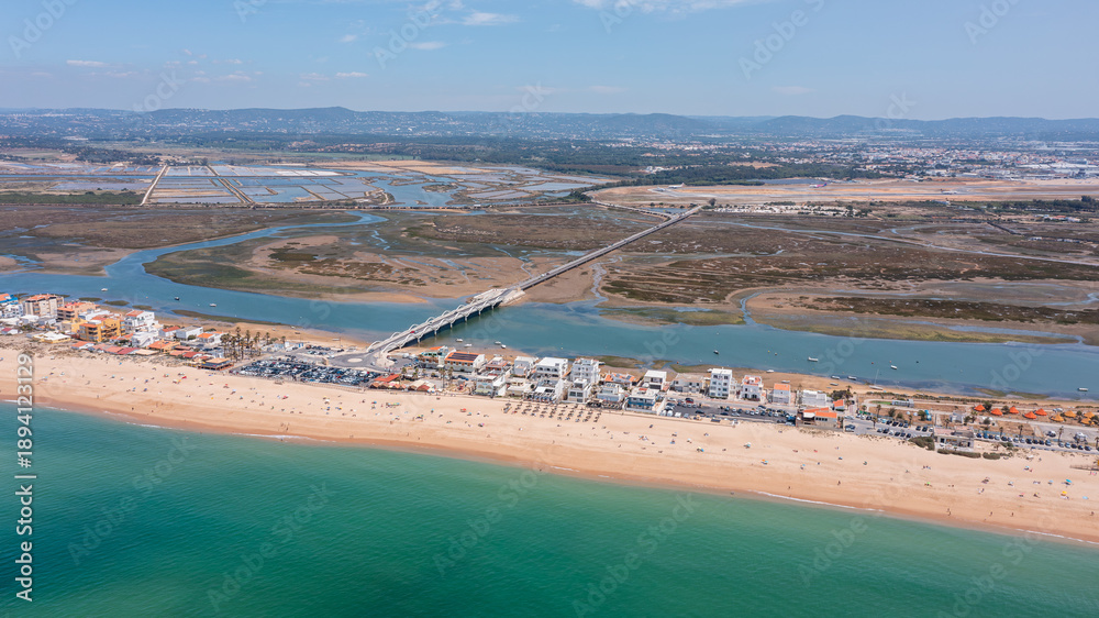 custom made wallpaper toronto digitalDrone captures praia de Faro and new bridge and Ria Formosa with sandy beach, water, and buildings along the coastline showing daily activities in the area
