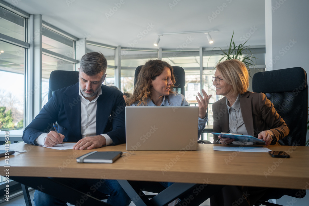 Fototapeta premium Laptop, collaboration and business people in the office while working on a company project. Technology, teamwork and team doing corporate research in discussion together with technology in workplace