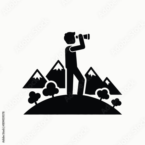 Person looking through a telescope or binoculars from a hill with mountains