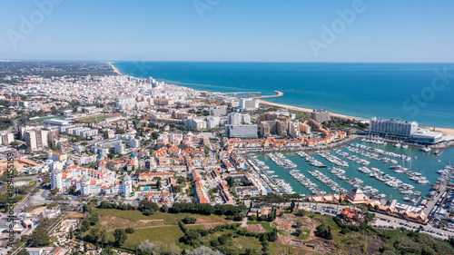 Принти на полотні Aerial view of Vilamoura Marina in Portugal shows boats docked alongside buildings