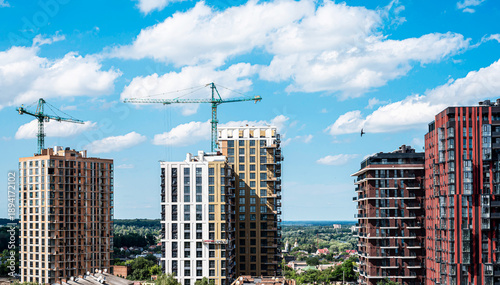Wallpaper Mural Modern multi-storey new buildings of different colors on a background of blue sky with clouds Torontodigital.ca