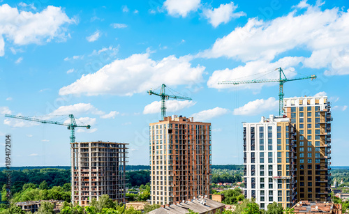 Wallpaper Mural Modern multi-storey new buildings of different colors on a background of blue sky with clouds Torontodigital.ca