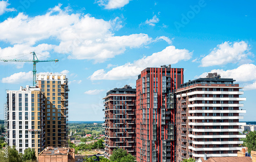 Wallpaper Mural Modern multi-storey new buildings of different colors on a background of blue sky with clouds Torontodigital.ca