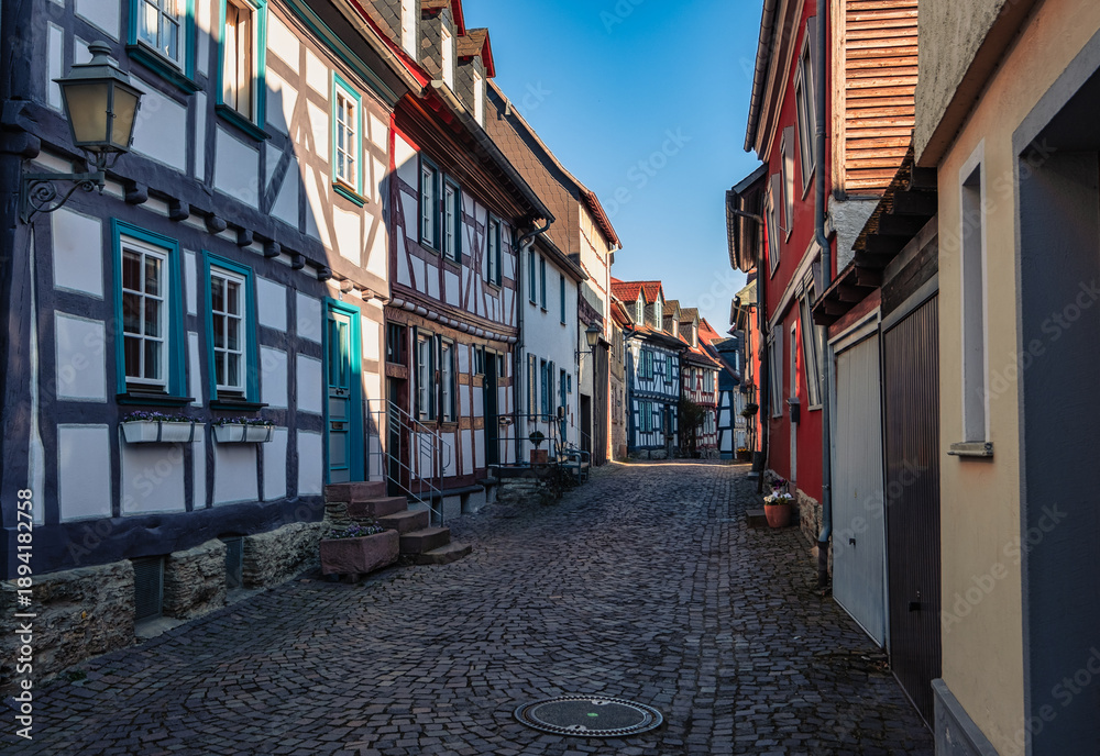 Fototapeta premium Narrow, romantic alleyways with cobblestones and half-timbered houses in Idstein in the Taunus region