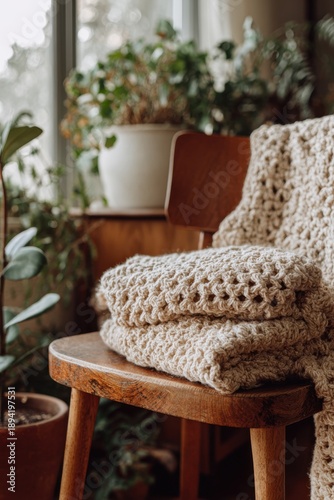 Cozy home interior with knitted blanket and indoor plants by window,national crochet month