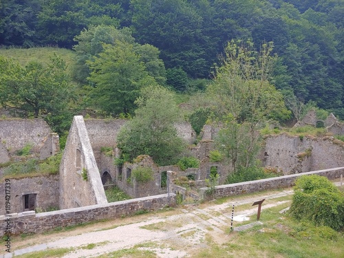 The Royal Arms and Munitions Factory, Navarre, Spain - July 10, 2019. Stone ruins integrated into a natural environment, surrounded by trees and vegetation. They correspond to old abandoned buildings 