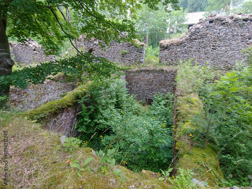 The Royal Arms and Munitions Factory, Navarre, Spain - July 10, 2019. Stone ruins integrated into a natural environment, surrounded by trees and vegetation. They correspond to old abandoned buildings 