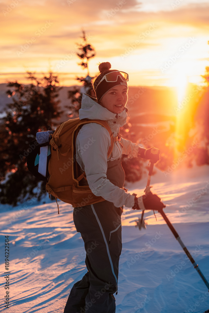 Fototapeta premium Mountaineer backcountry ski walking ski alpinist in the mountains. Ski touring in alpine landscape with snowy trees. Adventure winter sport. Low Tatras, slovakia