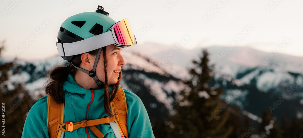 Fototapeta premium Mountaineer backcountry ski walking ski alpinist in the mountains. Ski touring in alpine landscape with snowy trees. Adventure winter sport. Low Tatras, slovakia