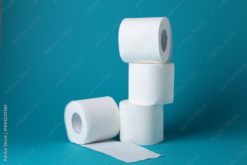 Obraz premium Rolls of toilet paper on light blue background